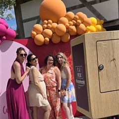 Invités devant la borne photo en bois